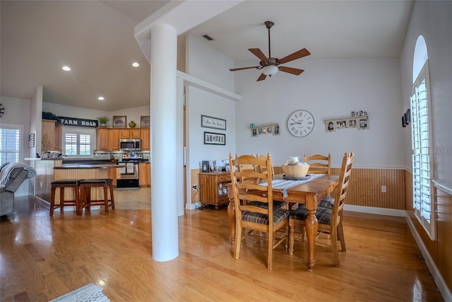 15141 Farm Rd, Groveland, FL 34736 - dining room with high vaulted ceiling, a wainscoted wall, light wood-style floors, visible vents, and a ceiling fan