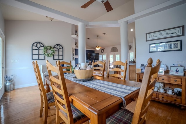 15141 Farm Rd, Groveland, FL 34736 - dining room featuring vaulted ceiling, ornate columns, wood finished floors, and a ceiling fan