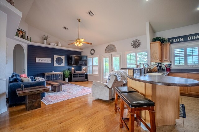 15141 Farm Rd, Groveland, FL 34736 - living room with light wood-style flooring, visible vents, and a healthy amount of sunlight