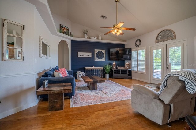 15141 Farm Rd, Groveland, FL 34736 - living room featuring visible vents, ceiling fan, wood finished floors, arched walkways, and lofted ceiling