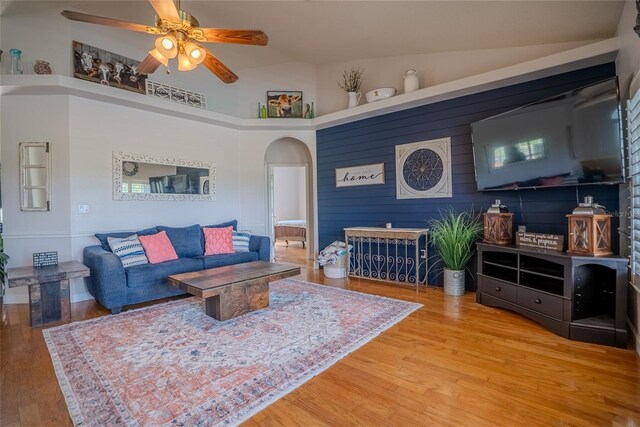 15141 Farm Rd, Groveland, FL 34736 - living room with high vaulted ceiling, wood finished floors, arched walkways, and a ceiling fan