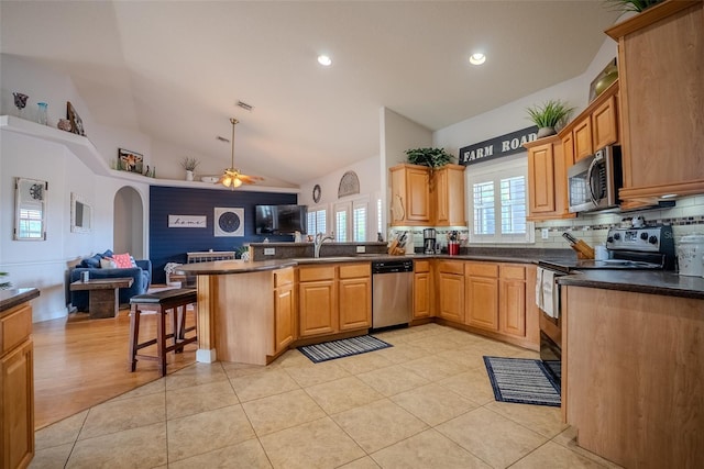 15141 Farm Rd, Groveland, FL 34736 - kitchen with open floor plan, a ceiling fan, a peninsula, and stainless steel appliances