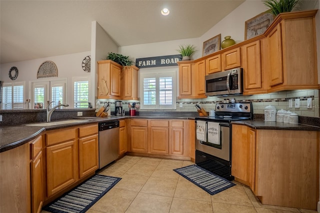 15141 Farm Rd, Groveland, FL 34736 - kitchen featuring vaulted ceiling, a sink, backsplash, appliances with stainless steel finishes, and light tile patterned floors
