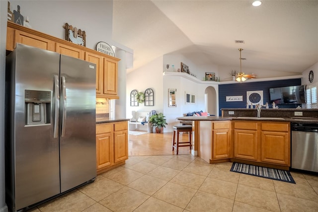 15141 Farm Rd, Groveland, FL 34736 - kitchen with vaulted ceiling, a ceiling fan, appliances with stainless steel finishes, open floor plan, and light tile patterned floors