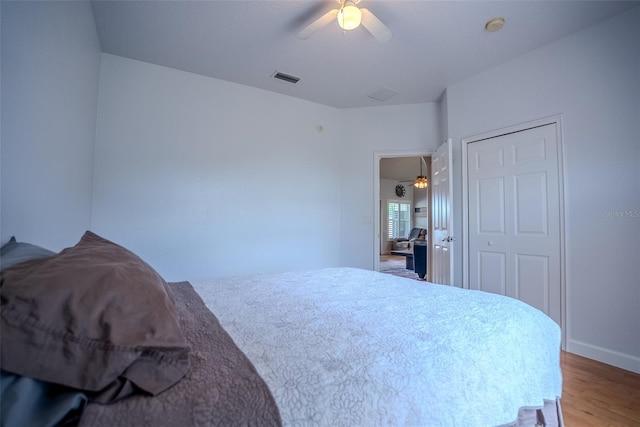 15141 Farm Rd, Groveland, FL 34736 - bedroom featuring visible vents, wood finished floors, and a ceiling fan