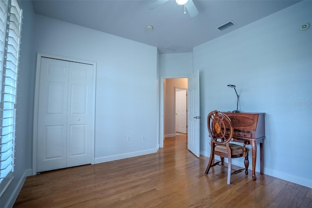 15141 Farm Rd, Groveland, FL 34736 - bedroom with baseboards, visible vents, a closet, and wood finished floors