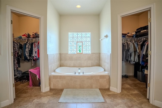 15141 Farm Rd, Groveland, FL 34736 - full bath with baseboards, tile patterned flooring, and a garden tub
