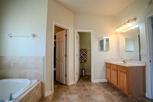 15141 Farm Rd, Groveland, FL 34736 - full bath featuring tile patterned flooring, vanity, baseboards, and a garden tub