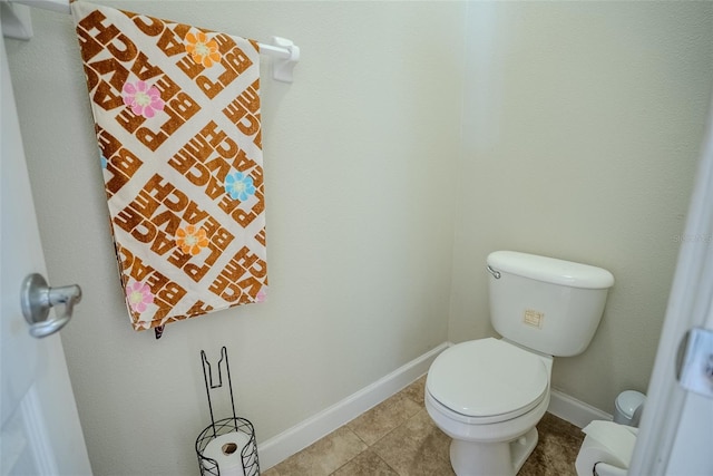 15141 Farm Rd, Groveland, FL 34736 - bathroom featuring baseboards, toilet, and tile patterned flooring