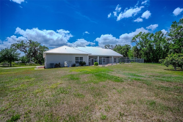 15141 Farm Rd, Groveland, FL 34736 - back of house featuring fence and a yard