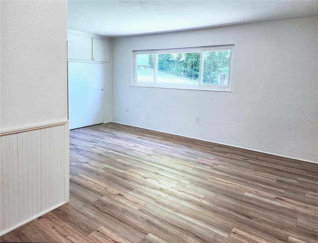 spare room with wood finished floors