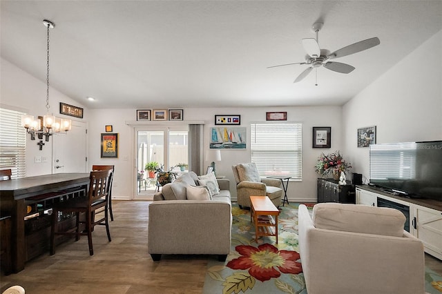living room with lofted ceiling, wood finished floors, and a wealth of natural light