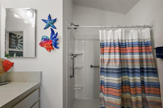 bathroom featuring vanity and a shower with shower curtain