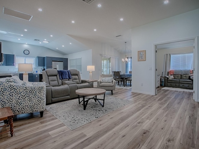 1010 Ventura Dr, The Villages, FL 32159 - living area featuring light wood finished floors, a notable chandelier, vaulted ceiling, and recessed lighting