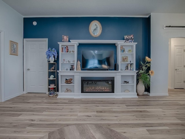 1010 Ventura Dr, The Villages, FL 32159 - living room with baseboards, a glass covered fireplace, and wood finished floors
