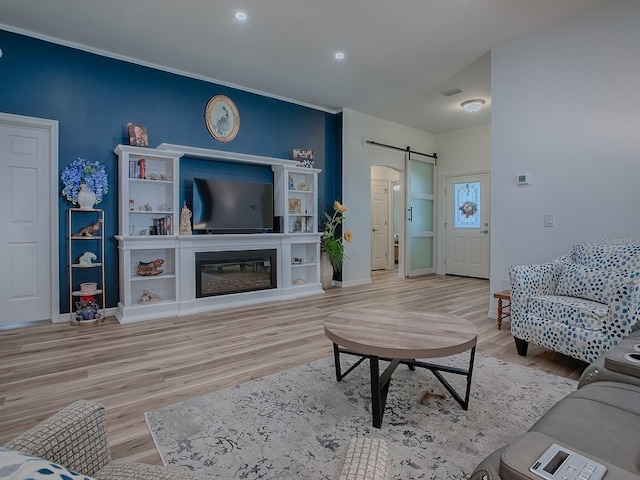 1010 Ventura Dr, The Villages, FL 32159 - living room with a barn door, visible vents, baseboards, and wood finished floors