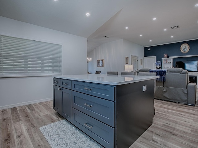 1010 Ventura Dr, The Villages, FL 32159 - kitchen featuring light wood-type flooring, visible vents, a center island, light countertops, and open floor plan