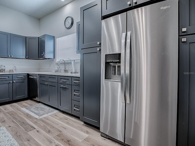 1010 Ventura Dr, The Villages, FL 32159 - kitchen featuring stainless steel fridge with ice dispenser, light wood finished floors, light countertops, and a sink
