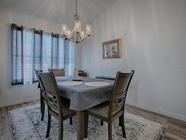 1010 Ventura Dr, The Villages, FL 32159 - dining room with baseboards, an inviting chandelier, and wood finished floors