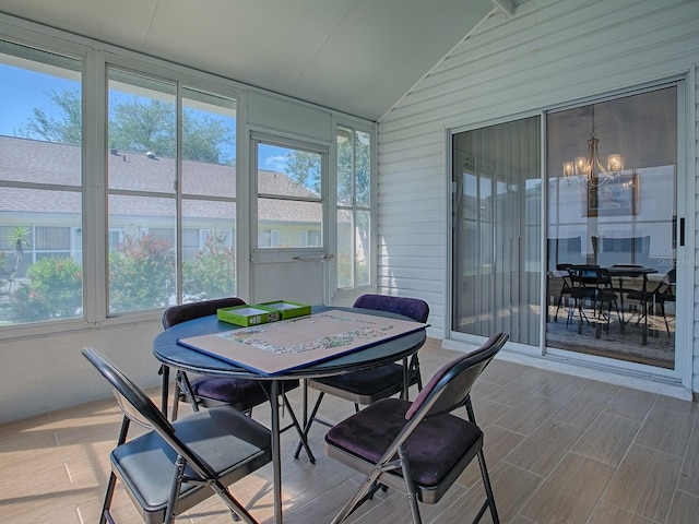 1010 Ventura Dr, The Villages, FL 32159 - sunroom / solarium featuring outdoor dining space, a notable chandelier, wood finish floors, and lofted ceiling