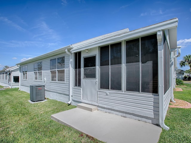 1010 Ventura Dr, The Villages, FL 32159 - back of house with a yard, central AC, and a sunroom