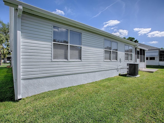 1010 Ventura Dr, The Villages, FL 32159 - view of home's exterior with a yard and central AC
