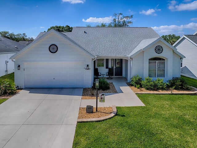 1010 Ventura Dr, The Villages, FL 32159 - ranch-style home with a garage, a front yard, roof with shingles, and driveway