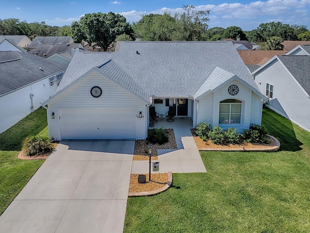 1010 Ventura Dr, The Villages, FL 32159 - single story home featuring roof with shingles, concrete driveway, a garage, and a front lawn