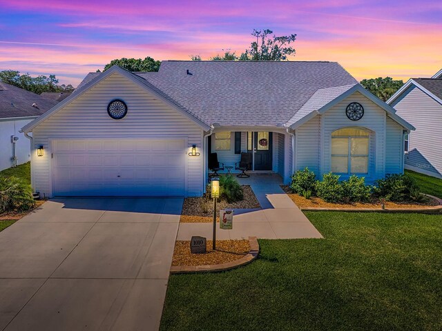 1010 Ventura Dr, The Villages, FL 32159 - ranch-style house with concrete driveway, a yard, roof with shingles, and a garage