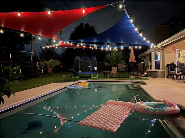 3511 Fox Lake Dr, Apopka, FL 32712 - pool at twilight featuring a patio area, an outdoor pool, and a lawn