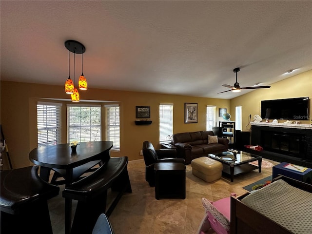 3511 Fox Lake Dr, Apopka, FL 32712 - living room with plenty of natural light, ceiling fan, a glass covered fireplace, and lofted ceiling