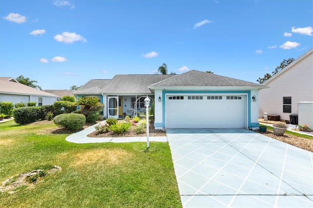 ranch-style home featuring concrete driveway, an attached garage, a front yard, stucco siding, and a shingled roof