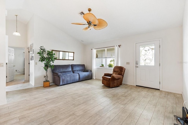 living room featuring light wood-style flooring, ceiling fan, high vaulted ceiling, and baseboards