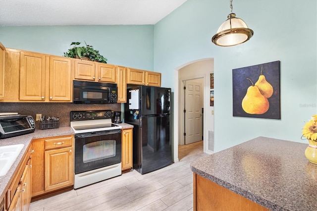 kitchen featuring black appliances, high vaulted ceiling, arched walkways, light wood-style flooring, and decorative backsplash
