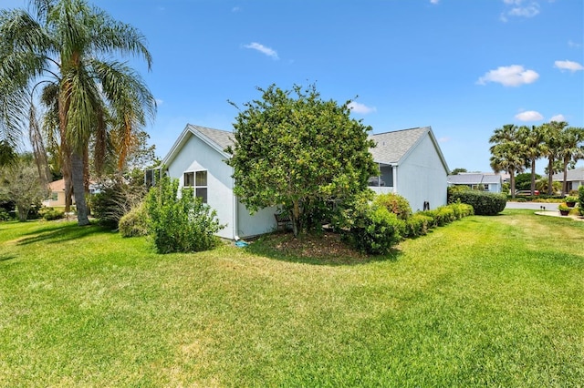 view of side of home with a lawn