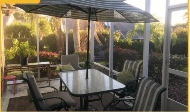 sunroom featuring outdoor dining space