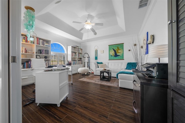 home office featuring a raised ceiling, ceiling fan, dark wood finished floors, and visible vents