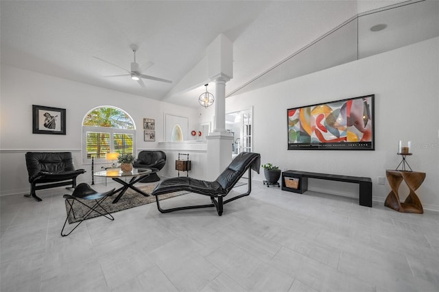 interior space featuring high vaulted ceiling, decorative columns, baseboards, and a ceiling fan