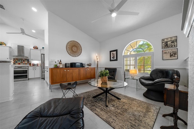 living area featuring visible vents, a ceiling fan, and high vaulted ceiling
