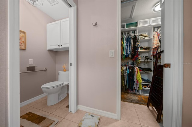 bathroom featuring visible vents, tile patterned flooring, baseboards, and toilet