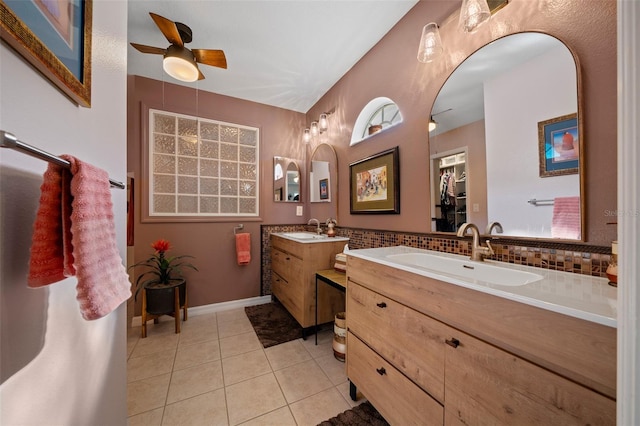bathroom featuring tasteful backsplash, a sink, ceiling fan, two vanities, and tile patterned flooring