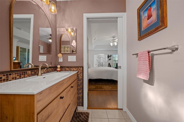 bathroom featuring tile patterned floors, baseboards, a ceiling fan, and connected bathroom