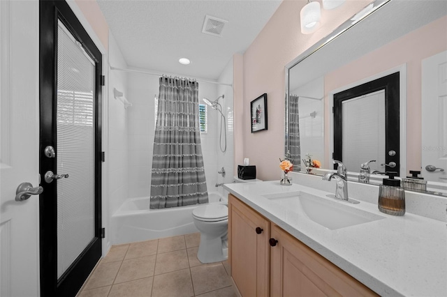 full bathroom featuring visible vents, shower / tub combo, toilet, vanity, and tile patterned flooring