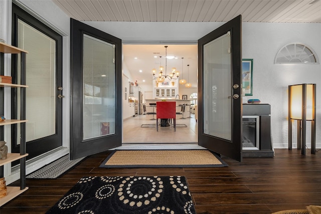 interior space with a chandelier, hardwood / wood-style floors, and french doors