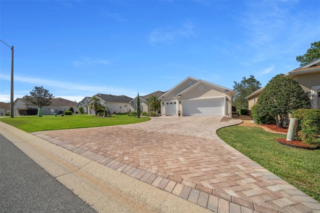 ranch-style home featuring an attached garage, stucco siding, a front lawn, a residential view, and decorative driveway