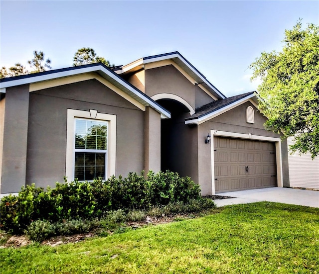 27 Perch Dr, Kissimmee, FL 34759 - ranch-style home featuring stucco siding, a garage, driveway, and a front yard