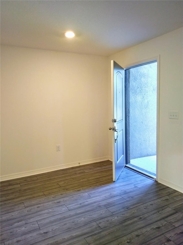 27 Perch Dr, Kissimmee, FL 34759 - empty room featuring dark wood-type flooring, baseboards, and recessed lighting