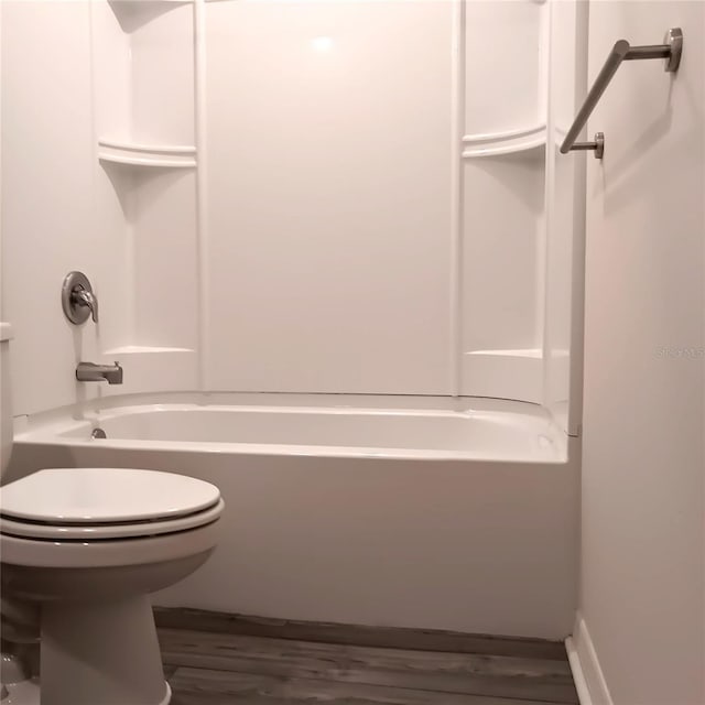 27 Perch Dr, Kissimmee, FL 34759 - bathroom with toilet, wood finished floors, and tub / shower combination