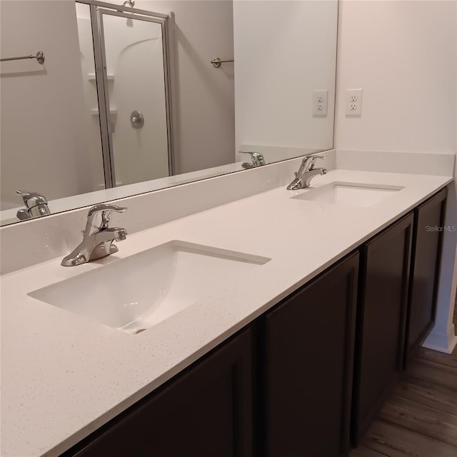 27 Perch Dr, Kissimmee, FL 34759 - full bath featuring double vanity, a shower with door, and wood finished floors