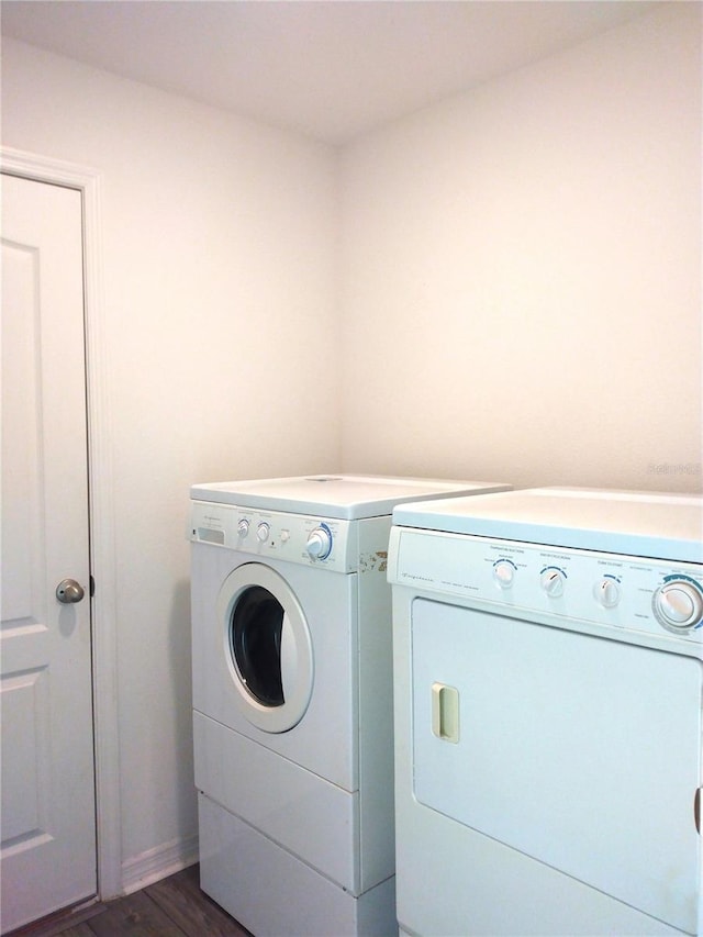 27 Perch Dr, Kissimmee, FL 34759 - laundry area with washing machine and clothes dryer and dark wood-style flooring